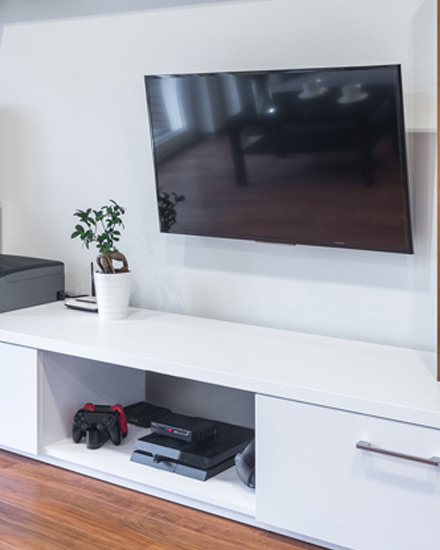 Un televisor de pantalla plana y otros electrodomésticos en una sala de estar.