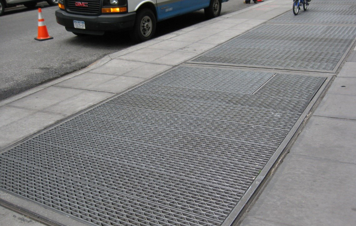 Ventilation covers on a sidewalk.