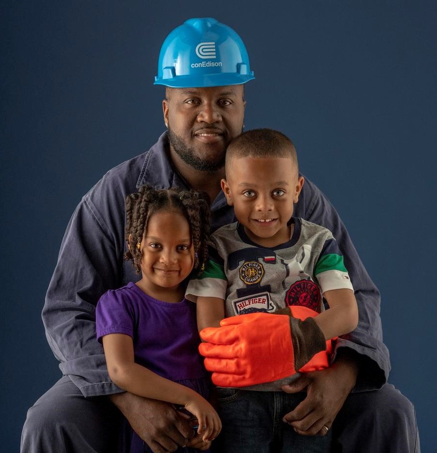 A Con Edison worker posing with his children.
