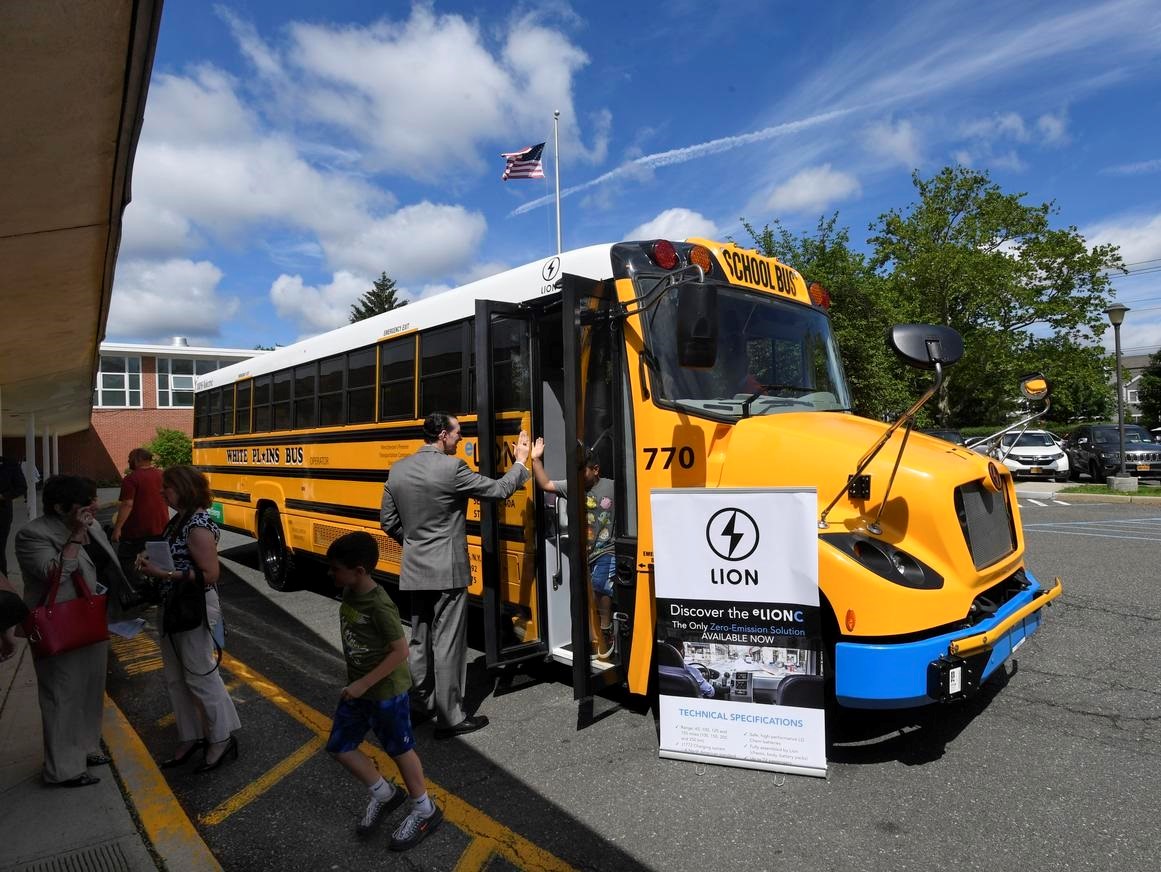 Students at a White Plains, N.Y. elementary school getting off a Lion electric school.