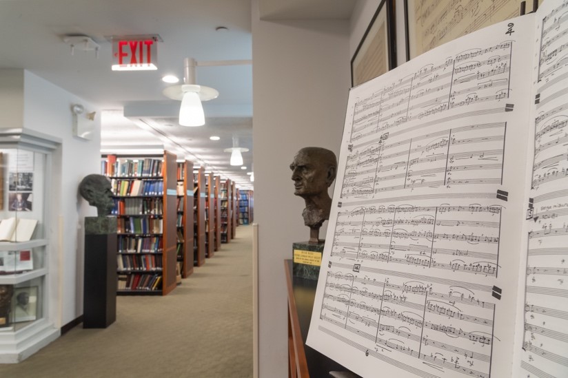 A library with shelves of books and sheet music on display.