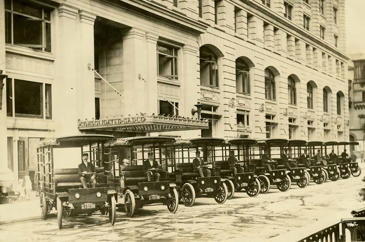 Historic image of Con Edison work vehicles parked outside the Consolidated Gas Company building during the early 1900's.