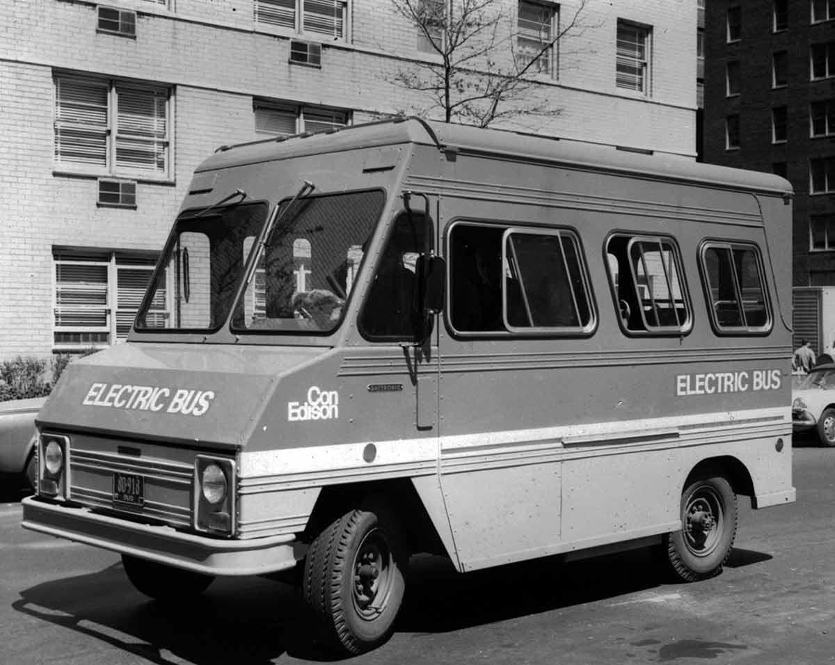 Black and white photo of a Con Edison bus driving through New York City.