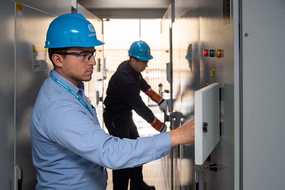 Two Con Edison employees working on large-scale energy storage system.