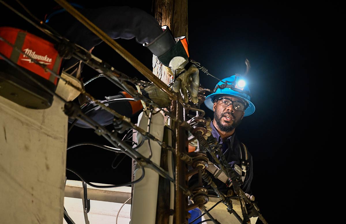 Overhead crews working at night to restore power following Hurricane Ida.
