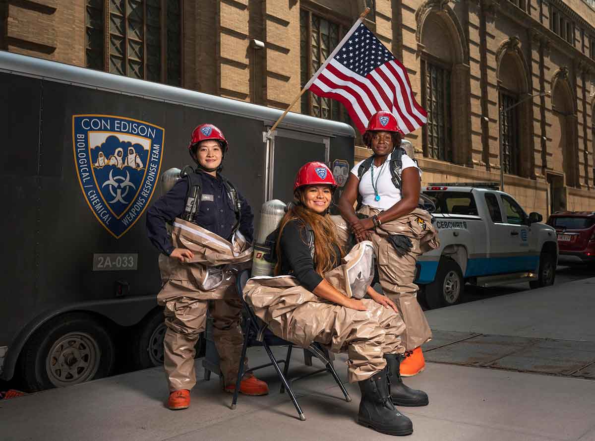 Women members of Con Edison's Hazardous Materials team posing on a city street.