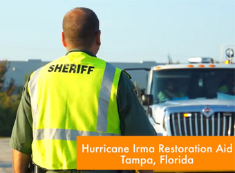 Sheriff of Tampa Florida directing traffic of restoration aid vehicles.
