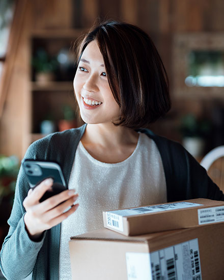 Woman on phone with packages she received