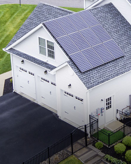 A residential home with a solar panel on the roof.