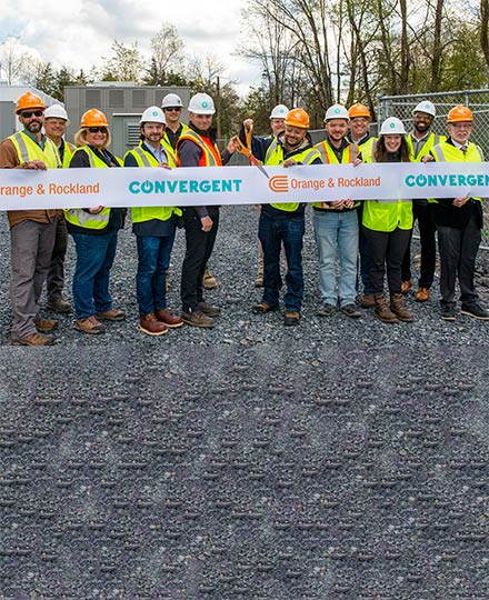 Orange and Rockland employees stand behind a ribbon for a ceremony opening at the Warwick, NY battery storage site.