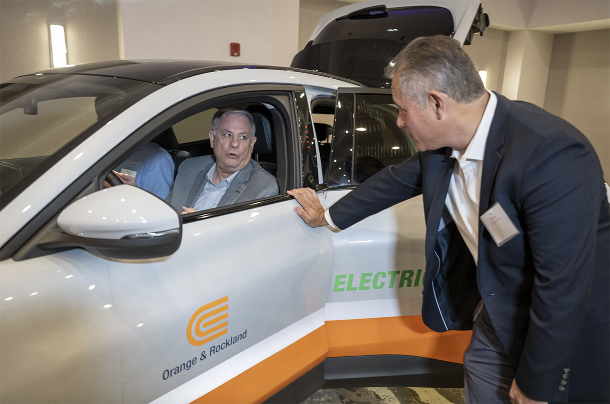 Bergen County Executive James J. Tedesco, III checks out the view behind the wheel of a Ford Mustang Mach-E at the Bergen Volunteers’ Friday Forum program, Supercharged. He is discussing the electric vehicle’s finer points with Orange and Rockland’s President and CEO Robert Sanchez. The Mach–E is Orange and Rockland’s electric car demonstration vehicle.